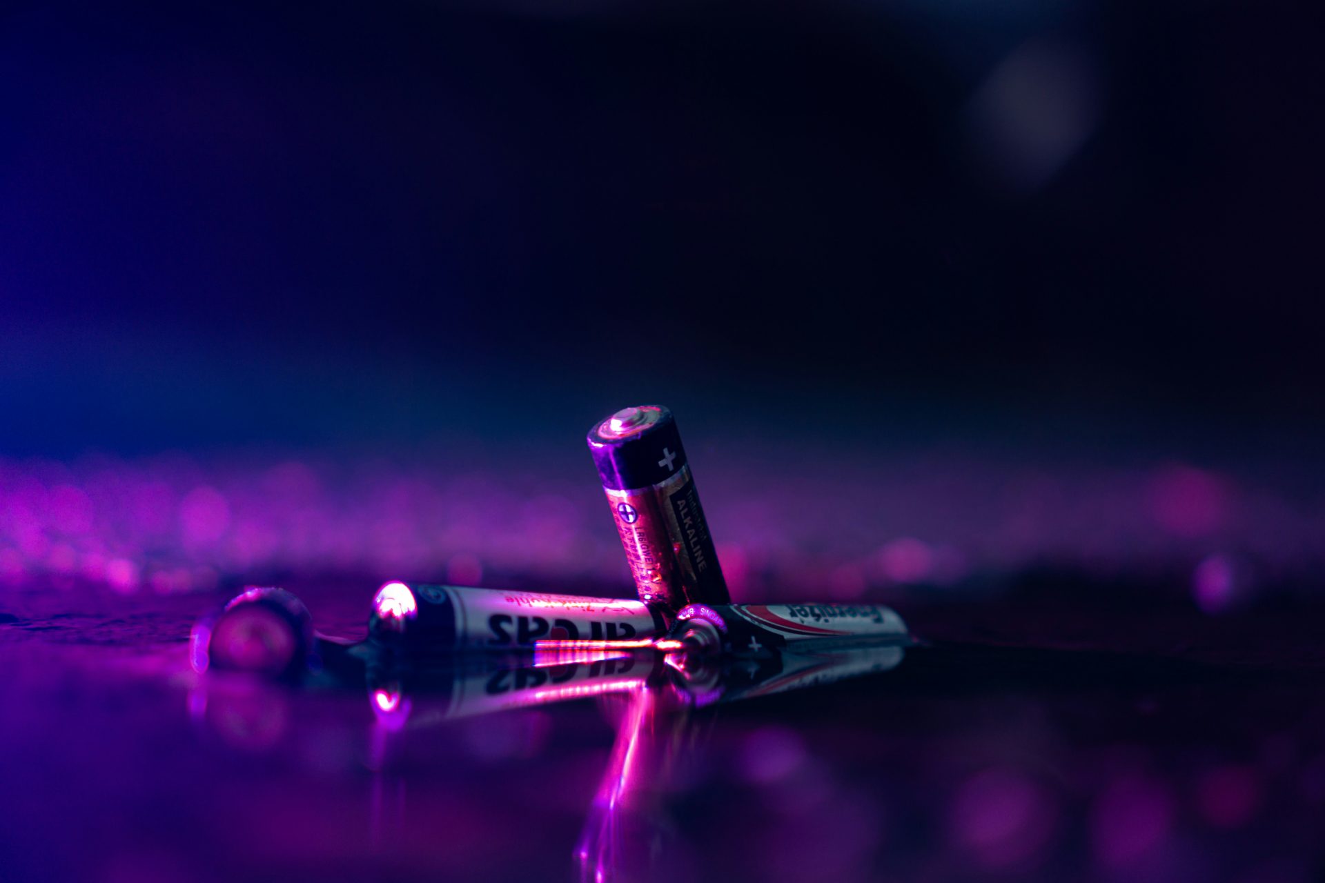 Old batteries in a purple light