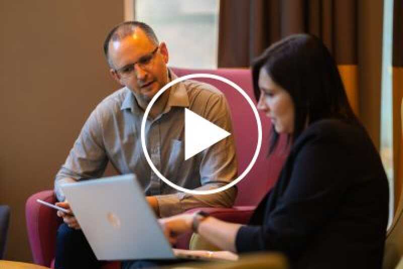 Two people talking at an event