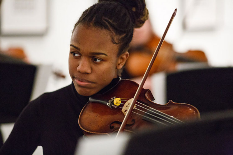 Female student holding a violin